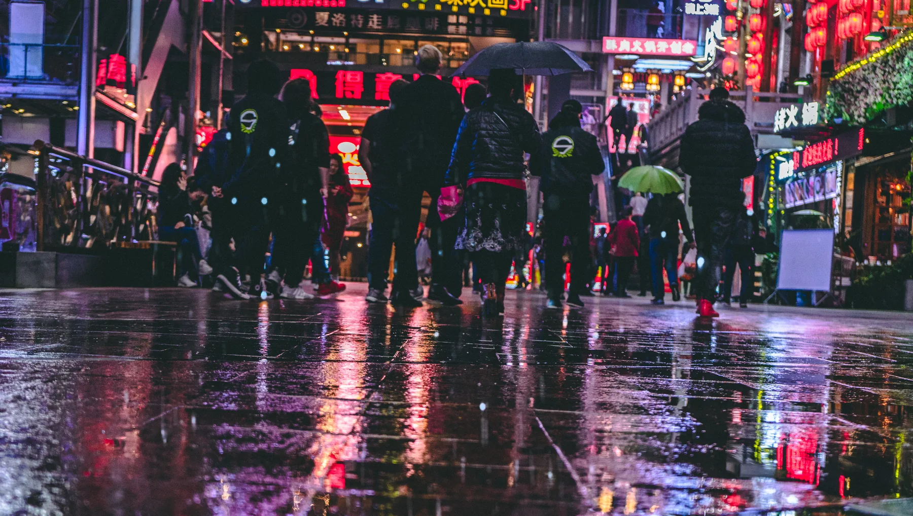 Team Singularity travelling through a neon-lit street in China