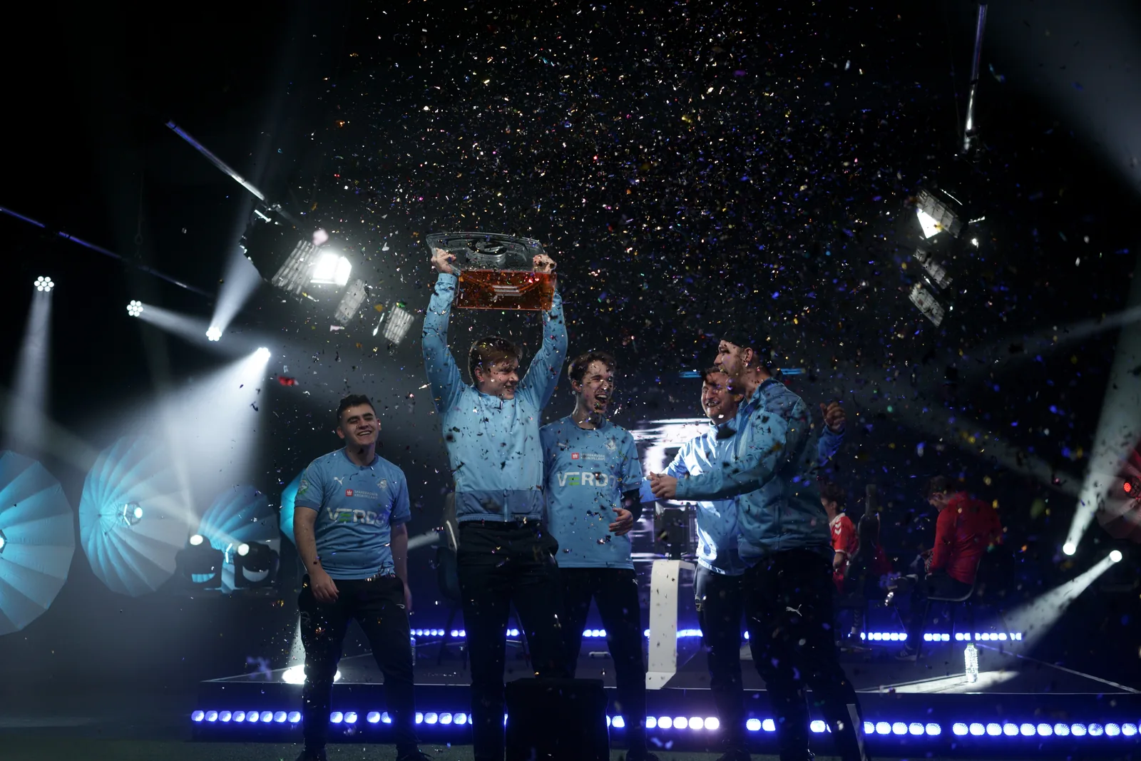 SNG Randers player celebrating with a trophy under confetti